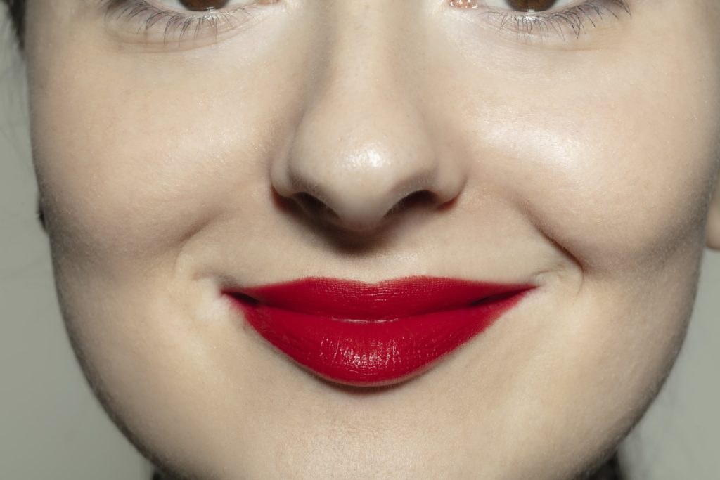 Woman's face with bright red lipstick